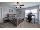 Cozy bedroom featuring a bed, ceiling fan, desk with a computer, and soft carpet, creating a comfortable atmosphere at 64 Roberson Ne Dr, Cartersville, GA 30121