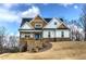 Charming two-story home with a welcoming front porch and stone accents, nestled on a lush green lawn at 64 Roberson Ne Dr, Cartersville, GA 30121