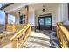 Picturesque covered front porch with stone and wood pillars, featuring double doors and decorative accents at 64 Roberson Ne Dr, Cartersville, GA 30121