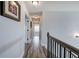 Hallway with wood-look flooring, light gray walls, and picture frames, giving a modern and stylish appearance at 64 Roberson Ne Dr, Cartersville, GA 30121