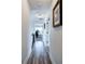 Hallway with wood-look flooring leading to a room with a desk and chair, providing a functional transition space at 64 Roberson Ne Dr, Cartersville, GA 30121