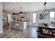 Open kitchen and dining area with stainless steel appliances, granite countertops, and modern fixtures at 64 Roberson Ne Dr, Cartersville, GA 30121