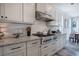 Kitchen featuring modern gas range and oven, light countertops, white subway tile, and wood floors at 64 Roberson Ne Dr, Cartersville, GA 30121