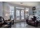 Living room with wooden floors, lots of natural light, and access to an outdoor deck at 64 Roberson Ne Dr, Cartersville, GA 30121