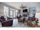 Comfortable living room with stone fireplace, ceiling fan, and leather furniture set at 64 Roberson Ne Dr, Cartersville, GA 30121