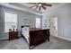 Comfortable main bedroom with ceiling fan, tray ceiling and neutral paint at 64 Roberson Ne Dr, Cartersville, GA 30121