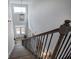 Elegant staircase with iron railings and a view of the front entry at 64 Roberson Ne Dr, Cartersville, GA 30121