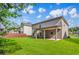 Spacious backyard featuring a covered patio and a well-maintained lawn at 2167 Dodson Woods Dr, Fairburn, GA 30213