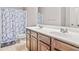 Bathroom featuring a double vanity, updated fixtures, and a shower-tub combo, offering modern comfort and convenience at 2167 Dodson Woods Dr, Fairburn, GA 30213