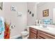 Well-lit half bathroom with vanity, decor, and a blue rug, providing a functional and stylish space at 2167 Dodson Woods Dr, Fairburn, GA 30213