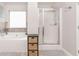 Bathroom featuring a soaking tub, glass-enclosed shower, and neutral color palette, creating a serene and relaxing environment at 2167 Dodson Woods Dr, Fairburn, GA 30213