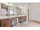 Bathroom with double vanity sinks, wood cabinetry, and a large mirror, offering plenty of space and functionality at 2167 Dodson Woods Dr, Fairburn, GA 30213
