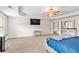 Bedroom featuring neutral carpet, tray ceilings and a TV, offering a comfortable and functional space at 2167 Dodson Woods Dr, Fairburn, GA 30213