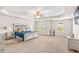 Large main bedroom features a tray ceiling, ceiling fan, windows, and comfortable carpeting at 2167 Dodson Woods Dr, Fairburn, GA 30213