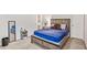 Well-lit bedroom boasting a wooden bed frame, modern decor, and an inviting atmosphere at 2167 Dodson Woods Dr, Fairburn, GA 30213