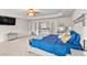 A bedroom with a tray ceiling, TV, and mirrored furniture set, providing a stylish and comfortable space at 2167 Dodson Woods Dr, Fairburn, GA 30213