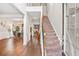Inviting foyer with hardwood floors, staircase, and views into dining and kitchen areas at 2167 Dodson Woods Dr, Fairburn, GA 30213