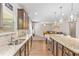 Open-concept kitchen with granite counters and island seating flows seamlessly into the living area at 2167 Dodson Woods Dr, Fairburn, GA 30213