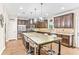 Open-concept kitchen featuring a large island, stainless steel appliances, and dark cabinetry at 2167 Dodson Woods Dr, Fairburn, GA 30213