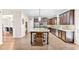 Open kitchen with center island, hardwood floors, stainless steel appliances, and eat-in kitchen area at 2167 Dodson Woods Dr, Fairburn, GA 30213