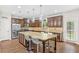Spacious kitchen with granite island, stainless appliances, and lots of dark wood cabinet storage at 2167 Dodson Woods Dr, Fairburn, GA 30213