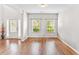 Bright and airy living room with hardwood floors, and natural light through large windows at 2167 Dodson Woods Dr, Fairburn, GA 30213