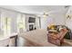 Cozy living room with a fireplace, large TV, ceiling fan, and neutral decor, offering a relaxing space at 2167 Dodson Woods Dr, Fairburn, GA 30213