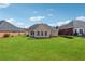 The property boasts a spacious backyard with lush green grass and a well-manicured landscape at 219 Prominent Loop, Mcdonough, GA 30253