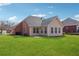 The beautiful backyard features a sunny patio and green lawn at 219 Prominent Loop, Mcdonough, GA 30253
