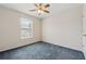 Bedroom featuring carpet floors, a ceiling fan, a window, and a door at 219 Prominent Loop, Mcdonough, GA 30253