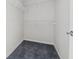 Walk-in closet shows carpet floor and white shelving for storage at 219 Prominent Loop, Mcdonough, GA 30253
