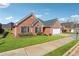 Beautiful single-story brick home with a well-maintained lawn, attached garage and black window shutters at 219 Prominent Loop, Mcdonough, GA 30253