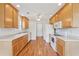 Functional kitchen with white appliances, linoleum floors, wood cabinets, and ample counter space for meal preparation at 219 Prominent Loop, Mcdonough, GA 30253