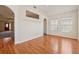 Well-lit sunroom featuring hardwood floors, archways, and large windows, creating a warm and inviting atmosphere at 219 Prominent Loop, Mcdonough, GA 30253