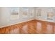 Inviting sunroom with hardwood floors, white trim, and plenty of natural light streaming through multiple windows at 219 Prominent Loop, Mcdonough, GA 30253