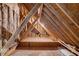 Unfinished attic space showcasing wood beams, insulation, and ample storage potential at 3141 Buck Branch Sw Rd, Conyers, GA 30094