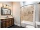 Well-lit bathroom featuring a decorative mirror, vanity and tiled shower with bathtub at 3141 Buck Branch Sw Rd, Conyers, GA 30094