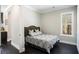 Cozy bedroom features a patterned bedspread, dark floors and plenty of natural light from the window at 3141 Buck Branch Sw Rd, Conyers, GA 30094