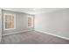 Well-lit bedroom with gray walls, plush carpet and large windows overlooking trees at 3141 Buck Branch Sw Rd, Conyers, GA 30094