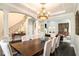 Elegant dining room featuring a large table, sophisticated chandelier, and staircase view at 3141 Buck Branch Sw Rd, Conyers, GA 30094