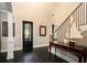 Elegant entryway with dark wood floors, decorative door, and staircase at 3141 Buck Branch Sw Rd, Conyers, GA 30094
