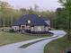 Spacious home featuring a manicured lawn, mature trees, and a long driveway for ample parking at 3141 Buck Branch Sw Rd, Conyers, GA 30094