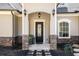 Inviting front entrance features a beautifully crafted door with elegant stone accents at 3141 Buck Branch Sw Rd, Conyers, GA 30094