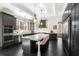 Beautiful kitchen with a large island, stainless steel appliances, dark cabinets, and sleek countertops at 3141 Buck Branch Sw Rd, Conyers, GA 30094