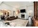 Open concept living room view into dining area features elegant fireplace and large leather sofa at 3141 Buck Branch Sw Rd, Conyers, GA 30094
