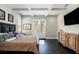 Well-lit main bedroom with hardwood floors, coffered ceilings, French doors, and a dark wood bed frame at 3141 Buck Branch Sw Rd, Conyers, GA 30094