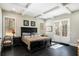 Bright main bedroom with hardwood floors, a dark wood bed frame, and French doors leading to the outdoors at 3141 Buck Branch Sw Rd, Conyers, GA 30094