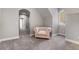 An upper-level sitting area features an upholstered armchair and arched entries at 3141 Buck Branch Sw Rd, Conyers, GA 30094