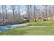 Lush green backyard with a shed and a covered pool at 523 Penny Ln, Woodstock, GA 30188