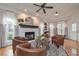 Cozy living room featuring a fireplace, hardwood floors, coffered ceiling, and abundant natural light at 9445 Grande Dr, Winston, GA 30187